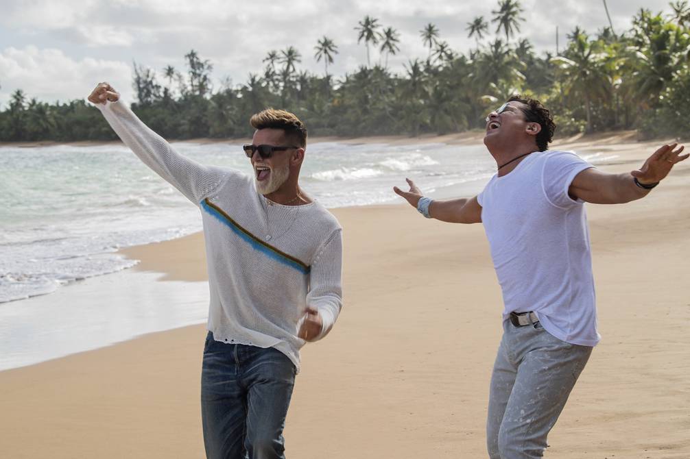 Two men dancing on the beach